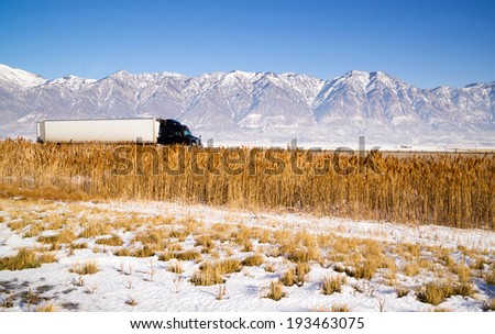 Snow Covered Mountains Behind Lakeside Highway Plant Growth Utah Landscape