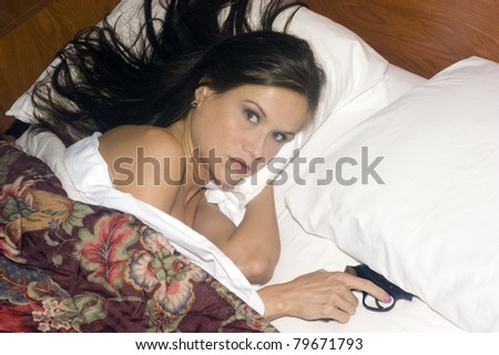 Woman in Bed Under Covers Gun Under Pillow Floral Comforter