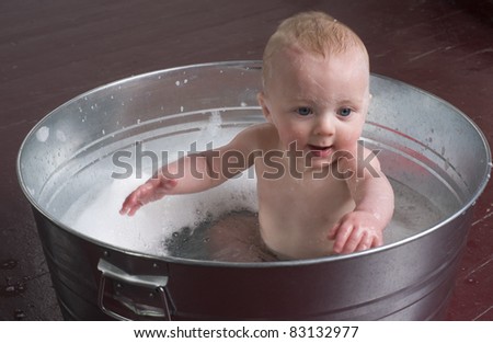 6 month old Boy bathing in a galvanized tub fun time child bubble bath