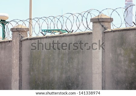 concrete walls with barbed wire for above