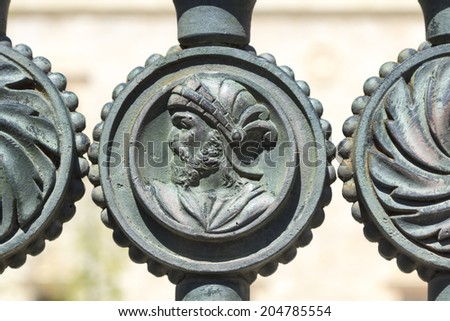 decorative details in an old iron fence