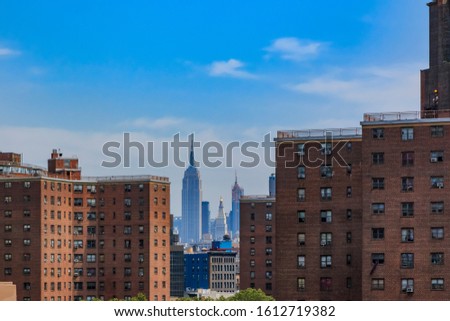Skyscrapers of Midtown Manhattan, country's commercial, entertainment, media and financial center behind brick facades in Lower Manhattan New York Stock fotó © 