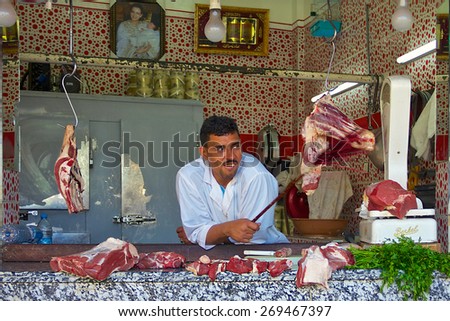 Fez, Morocco - May, 11, 2013: Butcher in an open air Moroccan market