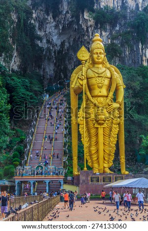 Kuala Lumpur, Malaysia - August 16, 2013: World\'s tallest golden statue of hindu god Lord Murugan at Batu Caves temple
