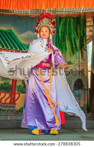 Georgetown, Penang, Malaysia - August 23, 2013: Chinese opera actors performming a public show. Chinese opera orginated in the Tang dynasty cira 720 AD.