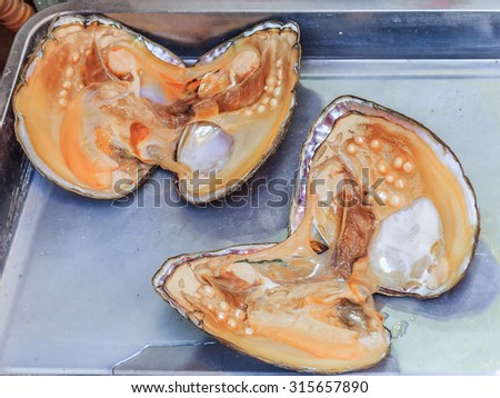 Pearl oyster shell with pearls inside for sale at the market in China