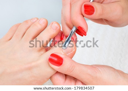 body care series. pedicure applying - toe nails cleaning and moisturizing with special solution.