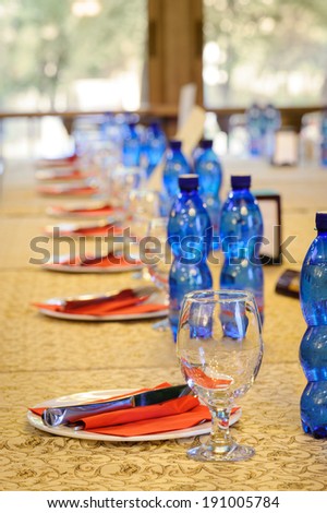 official banquet table with empty dishes and glasses at beginning
