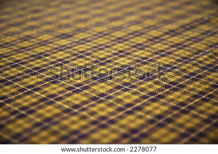 checkered celtic-style fabric textured background. shallow DOF.