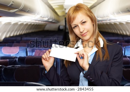 blond air hostess (stewardess) in the empty airliner cabin