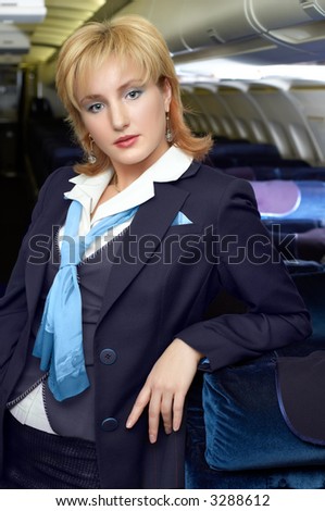 air hostess (stewardess) in the empty airliner cabin