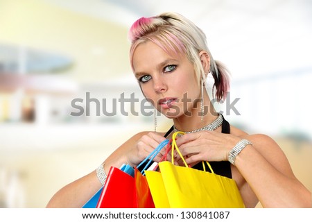 Gorgeous girl with shopping bags inside a mall