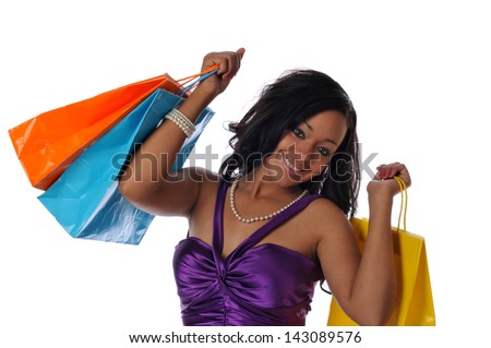 Young Black woman with shopping bags sand smiling isolated on a white background