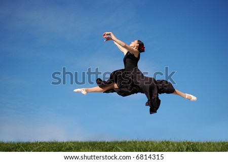 Dancer jumping against a blue sky
