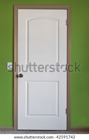 White door with green wall on a vertical format