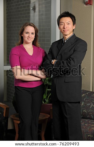 Young businessman and businesswoman inside an office building