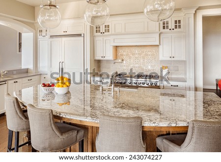 Kitchen with Island, Sink, Cabinets, and Hardwood Floors