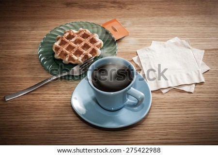 Space for your coffee shop\'s or restaurant\'s logo or message on napkins next to coffee and a snack.