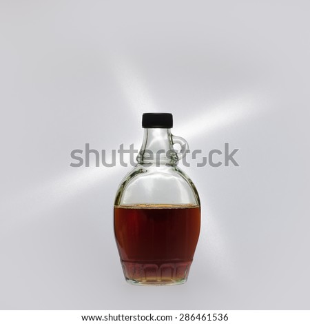 A bottle of maple syrup on display against a white background.