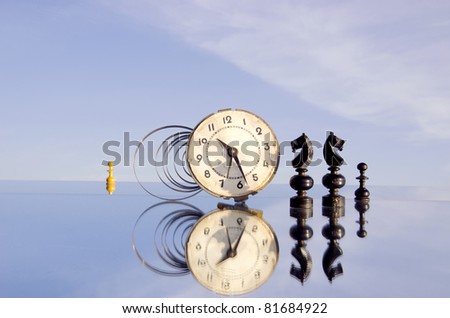 vintage clock and chessmans on mirror and sky