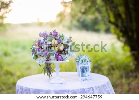 Beautiful bride with a bouquet of delicate lilac flowers, summer, wedding day