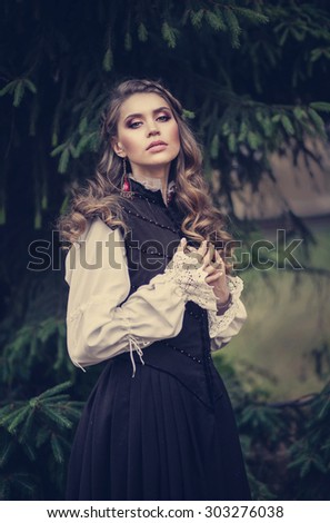 Beautiful feminine woman in a romantic way, old historical dress, long hair
