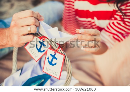 Man and woman holding paper boats, date. love, focus on hands