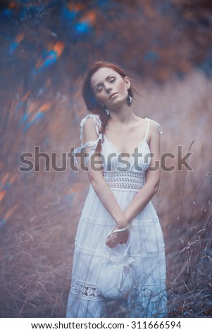A mysterious woman in the summer garden in the evening, a mysterious female image