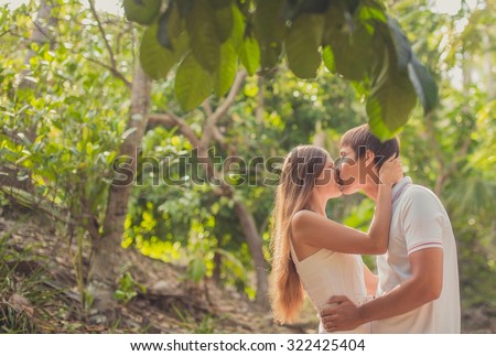 Man and woman. couple tourists embrace and kiss in the tropical jungle in Thailand