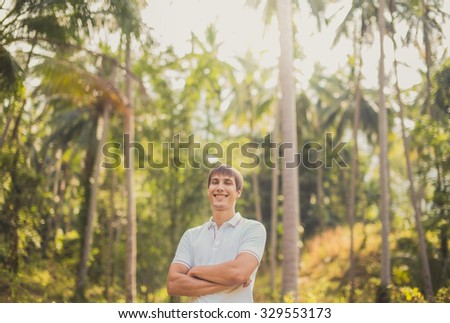 Young man tourist on holiday in the jungle. tourism, exotic, smile