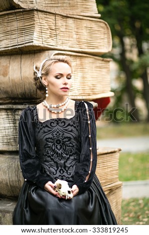 https://image.shutterstock.com/display_pic_with_logo/733378/333819245/stock-photo-beautiful-young-woman-in-medieval-dress-with-black-satin-pearl-necklace-sitting-with-cherppom-fox-333819245.jpg