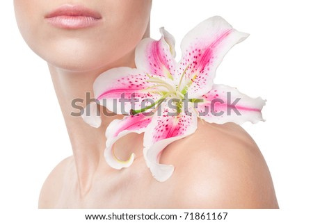 Beautiful girl with lily on a shoulder on a white background, cut off by his lips