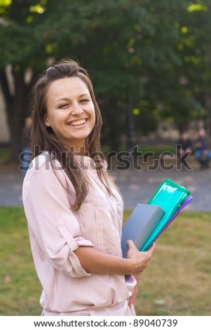 Young female student walks in the park,European, White, Caucasian,