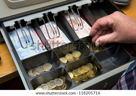 Cash money in drawer at a paydesk in a store