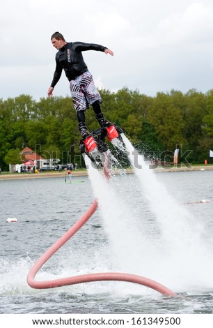 ENSCHEDE, NETHERLANDS - MAY 12: A man is giving a show how to keep in balance, and shows what you can do with the new sensation called flyboarding, May 12, 2013 in the Netherlands.