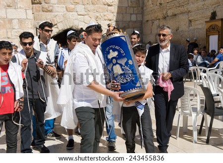 JERUSALEM, ISRAEL - OCT 06, 2014: Bar Mitzvah ritual at the Wailing wall in Jerusalem. A 13 years old boy who has become Bar Mitzvah is morally and ethically responsible for his decisions and actions