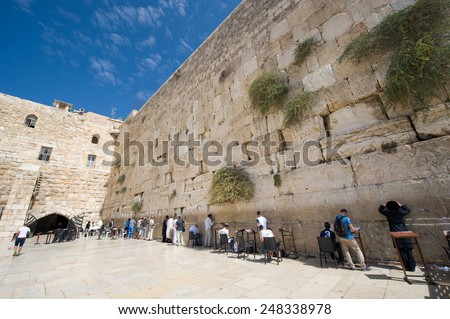 JERUSALEM, ISRAEL - OCT 07, 2014: Jewish men are praying in front of the western wall in the old city of Jerusalem