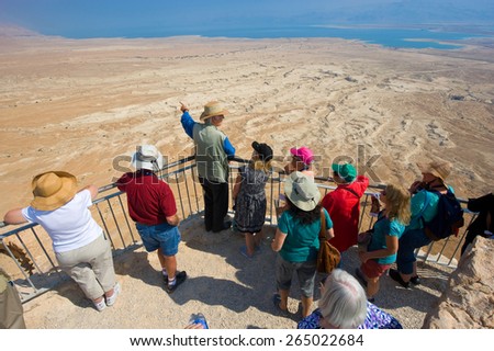 MASADA, ISRAEL - OCT 14, 2014: A guide gifts an explanation about Masada to tourists