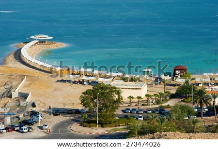 DEAD SEA, ISRAEL - OCT 13, 2014: People relaxing in the water of the dead sea at a resort in Israel