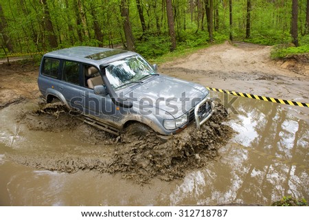 FURSTENAU, GERMANY - MAY 09, 2015: A land cruiser is driving through a pond of water on a special off the road terrain for land cruisers and vehicles in Germany