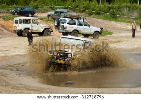 FURSTENAU, GERMANY - MAY 09, 2015: A Toyota 4-wheel drive is driving through a pond of water on a special off the road terrain for land cruisers and vehicles in Germany