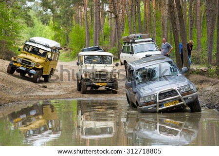 FURSTENAU, GERMANY - MAY 09, 2015: A Toyota Land Cruiser is stuck in a pond of water on a special off the road terrain for land cruisers and vehicles in Germany