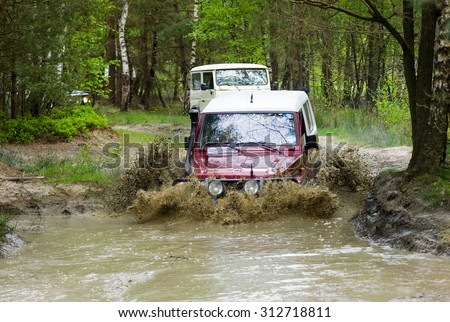FURSTENAU, GERMANY - MAY 09, 2015: A Toyota is driving through a pond of water on a special off the road terrain for land cruisers and vehicles in Germany