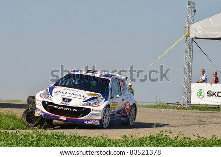 ZLIN,CZECH REP.-AUGUST 27. Driver Valousek P. and co-driver Hruza Z. with car Peugeot 207 S2000 at Barum Rally event,speed check Nr 2.August 27.2011 in Zlin,Czech republic