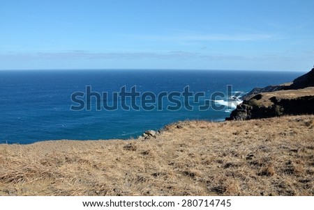 The edge of a cliff gives away to the blue waters of the Atlantic ocean, defining the true meaning of Island life in Fogo, Cabo Verde