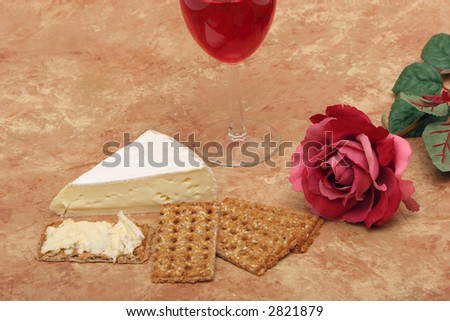 Red wine, cheese, crackers and rose