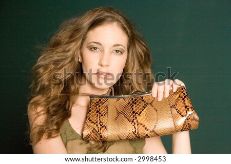 Beautiful young woman holding a purse