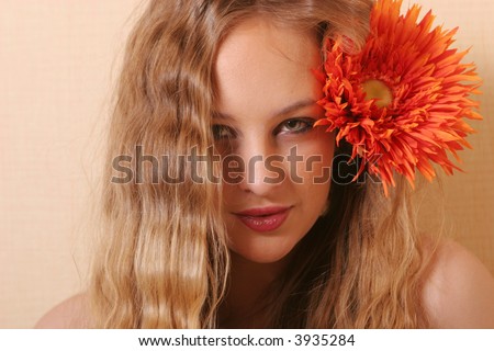 Sexy young blond woman with daisy on her hair