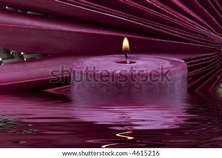 Lit spa candle in water