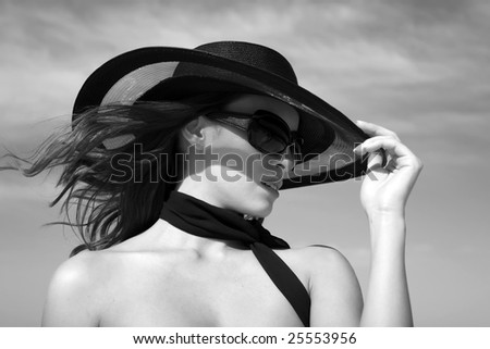 Sexy fashion model wearing hat and sunglasses